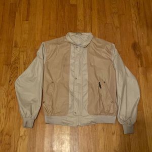 This is a semi new members only two toned creme colored windbreaker jacket.